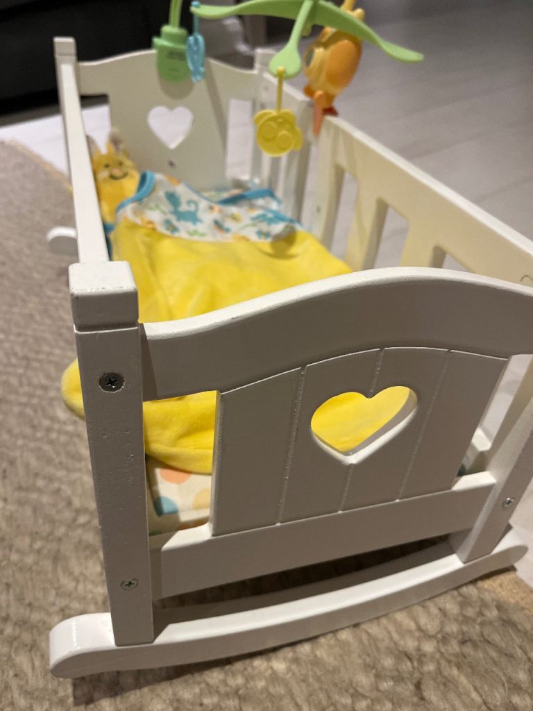 White wooden rocking baby crib with heart cutout for sale