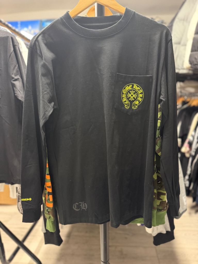 Black long sleeve shirt with green pocket graphic
