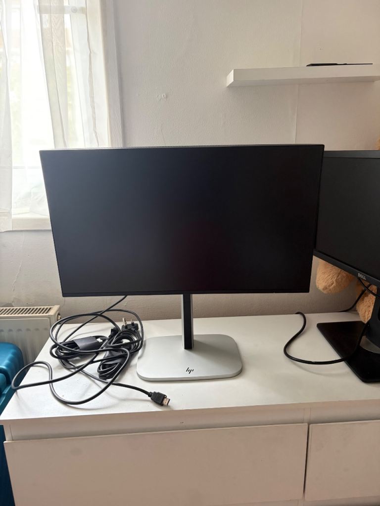 Black HP Monitor with Silver Base and Cables